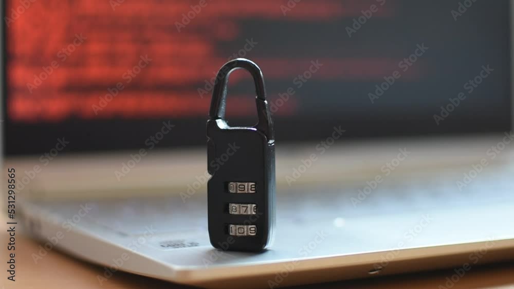 Locked metal padlock on a laptop keyboard over redbackground. Cyber security, antivirus software concept