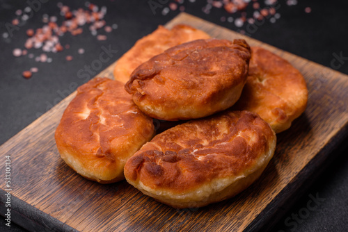 Cooking pies with potato on a wooden cutting board