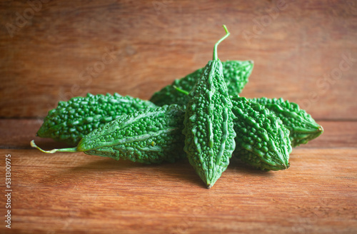 Wild bitter gourd on a wooden background.