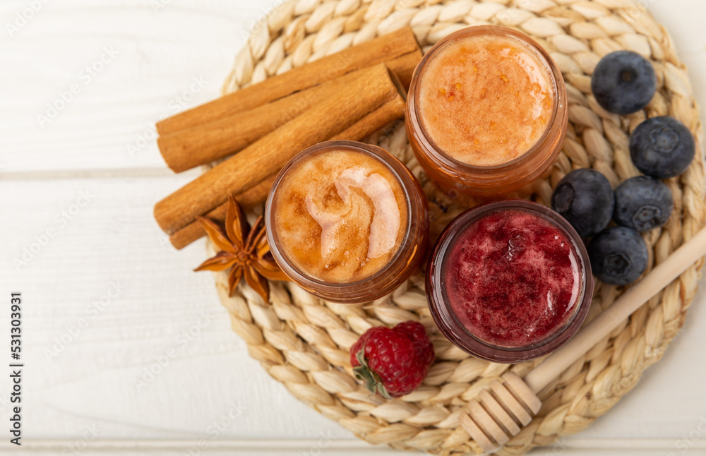 Jar of honey. Fruit honey with raspberries and blueberries.Useful fortified beekeeping product for health and beauty.Cream honey.Vegetarian diet organic product.Copy space. place for text Jar of honey. Fruit honey with raspberries and blueberries.Useful fortified beekeeping product for health and beauty.Cream honey.Vegetarian diet organic product.Copy space. place for text