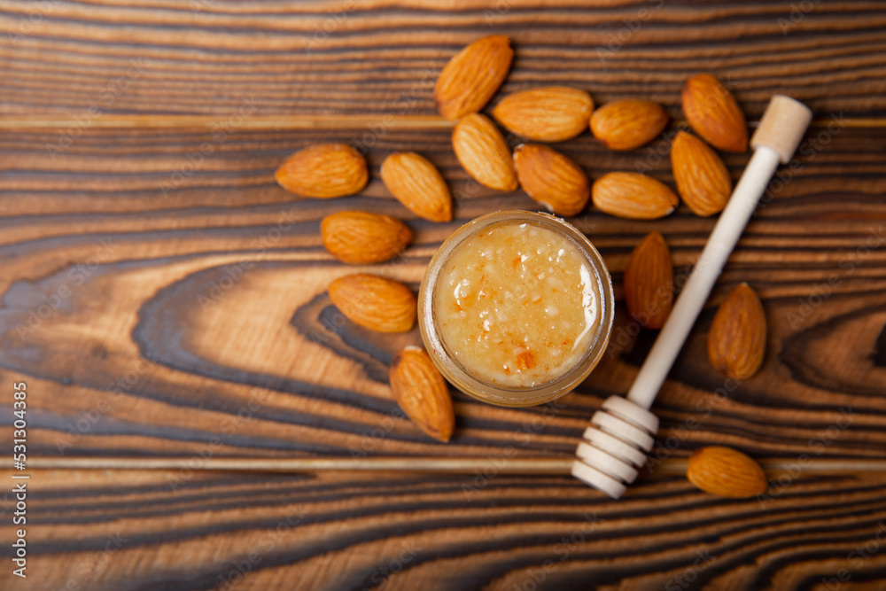Jar of honey. Almond honey.Useful fortified beekeeping product for health and beauty.Cream honey.Vegetarian diet organic product.Copy space. place for text Jar of honey. Almond honey.Useful fortified beekeeping product for health and beauty.Cream honey.Vegetarian diet organic product.Copy space. place for text