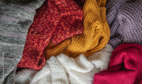 Autumn and winter background with knitted colourful sweaters