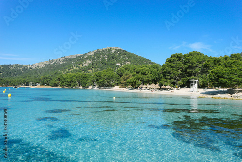 Beautiful turquoise mediterranean waters with mountains around in spanish island with white sand beaches 
