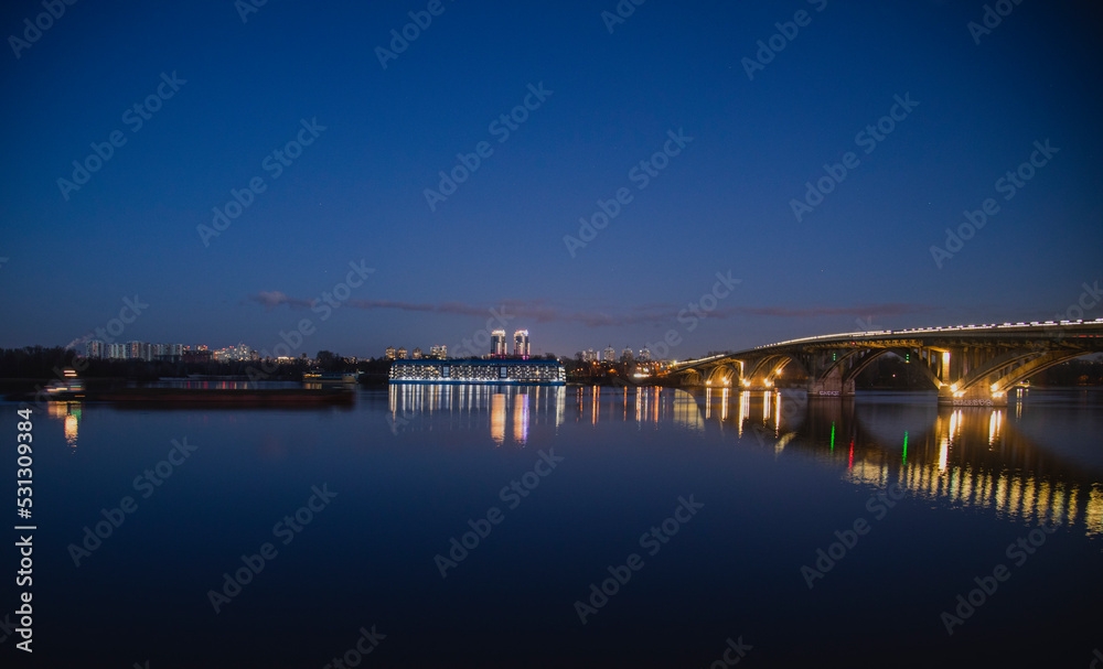 KIEV, UKRAINE - JANUARY 6, 2020: PARK BRIDGE (pedestrian bridge) ILLUMINATED BY NIGHT KIEV, UKRAINE - JANUARY 6, 2020: PARK BRIDGE (pedestrian bridge) ILLUMINATED BY NIGHT