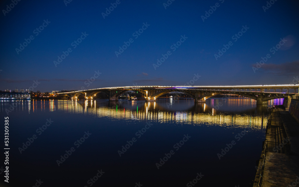 KIEV, UKRAINE - JANUARY 6, 2020: PARK BRIDGE (pedestrian bridge) ILLUMINATED BY NIGHT KIEV, UKRAINE - JANUARY 6, 2020: PARK BRIDGE (pedestrian bridge) ILLUMINATED BY NIGHT