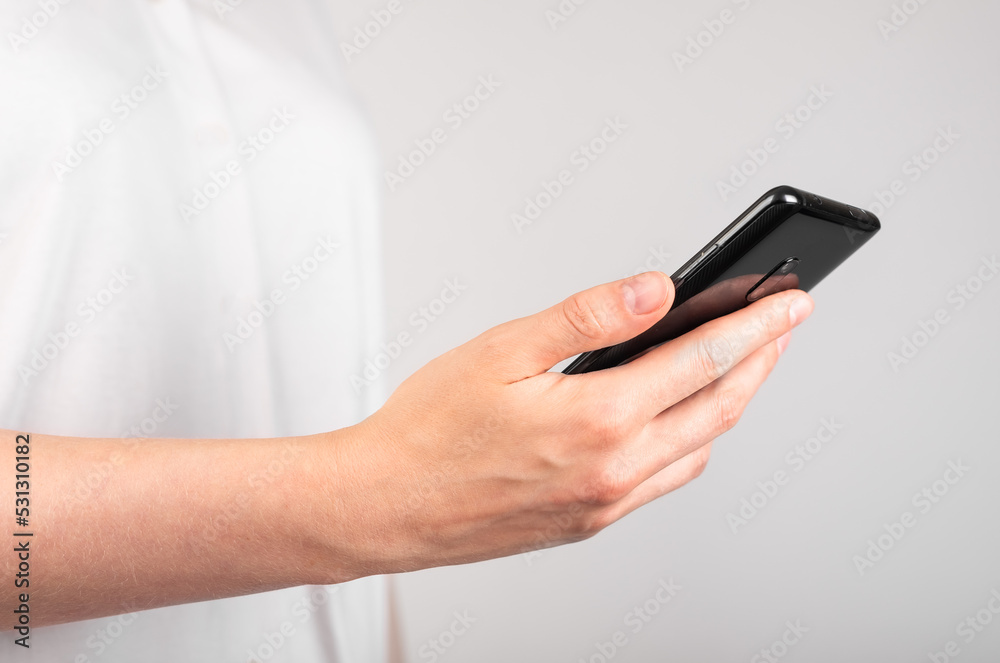 Woman hand holding phone. Using device in common life. Profile view