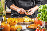 mid section of chef preparing fresh organic ingredients for pumpkin soup