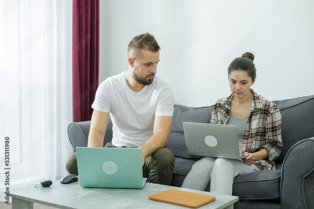 Couple at home doing online shopping with laptop Couple at home doing online shopping with laptop