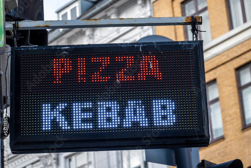 Copenhagen, Denmark A small neon sign sign for pizza and kebab at a snack bar.