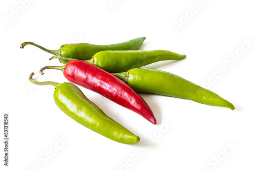 Several green and one red hot chili pepper pods