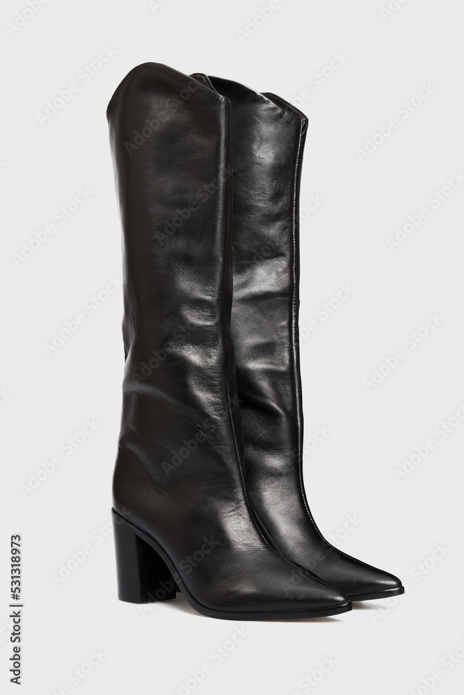 Blank black women's leather knee high boots isolated on white background. Female classic fashion spring autumn shoes with Pointy Toe, high heel. Template, mock up