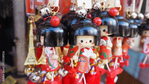 Closeup of Wooden Japanese Kokeshi Cute Girl in Ornament Red Doll Ring Souvenirs at Asakusa street