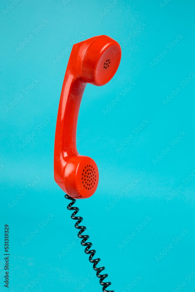 Old phone on a blue background. Antique phone with a tube. Red telephone  with a receiver. Retro telephone Stock Photo | Adobe Stock