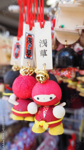 Closeup of Wooden Japanese Funny Red Ninja Doll Ring ang Blessing Tag Souvenirs at Asakusa street, Sensoji temple