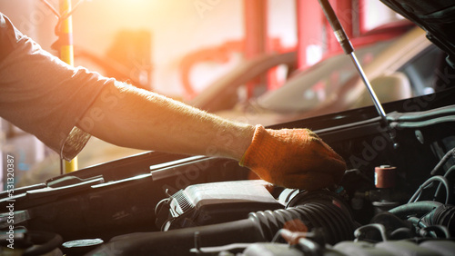 Auto mechanic repairs car engine. car service. auto repair shop. sunlight