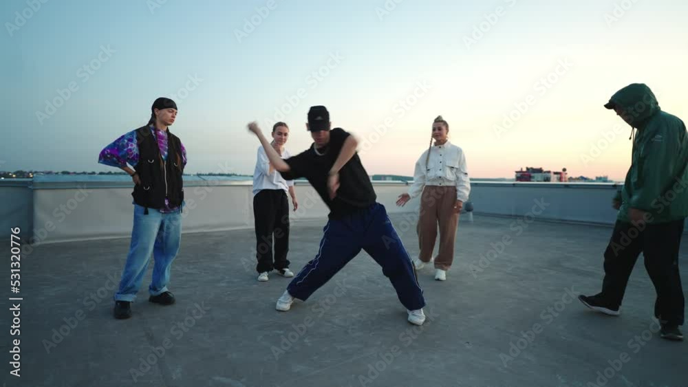 cool b-boy is dancing hip-hop style in breakdance battle and friendly party on roof cool b-boy is dancing hip-hop style in breakdance battle and friendly party on roof