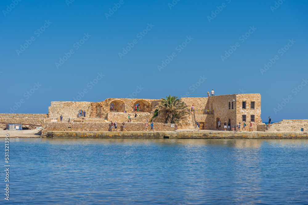 Chania with the amazing lighthouse, mosque, venetian shipyards, at sunset, Crete, Greece.