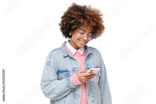 Smiling african american teenage girl with afro hairstyle, holding  phone with one hand, chatting with friend, using social media app, isolated photo