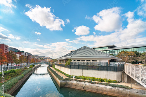nagasaki, kyushu - december 12 2021: Channel or moat around the Waterfront park restaurant and Winery of the Nagasaki Civic Hall with a the retro Orandasaka Bridge along the Oura Kaigan street.