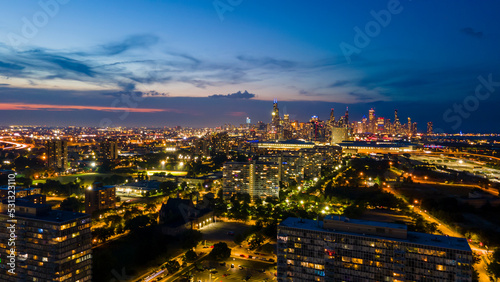 Chicago. IL USA October 15th 2022  aerial view of a Chicago metropolitan area at night. the streets light are bright and colorful as traffic goes steadily along the freeway 