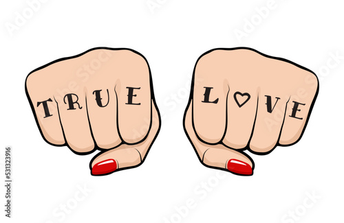 Female fist with True Love tattoo on fingers, front view of a woman fist with tattoo and polished nails