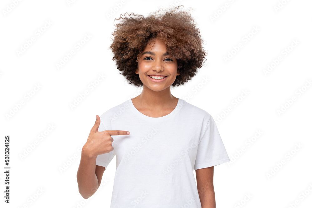 Smiling african girl pointing at her blank white t-shirt with index finger, copy space for your logo, isolated Smiling african girl pointing at her blank white t-shirt with index finger, copy space for your logo, isolated
