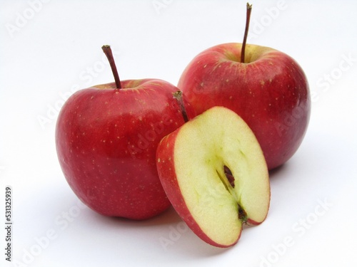 Red apples with half sliced apple isolated on white background 