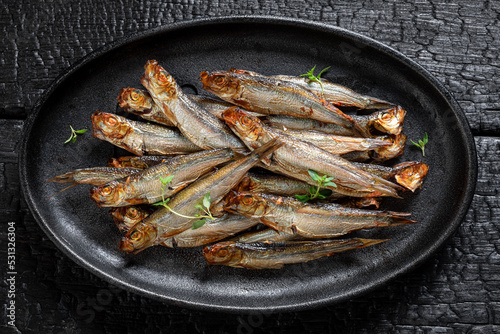 Healthy smoked sprats marinated with spices and salt. photo
