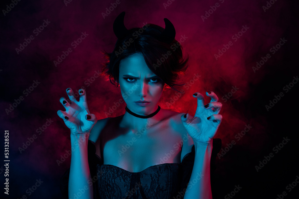 Photo of passionate satanic lady in devil costume attacking isolated on  smoke colored dark background Stock Photo | Adobe Stock