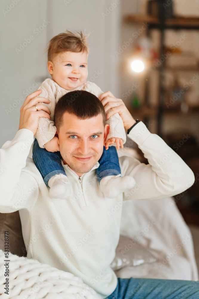 Dad riding his young son on shoulders. 