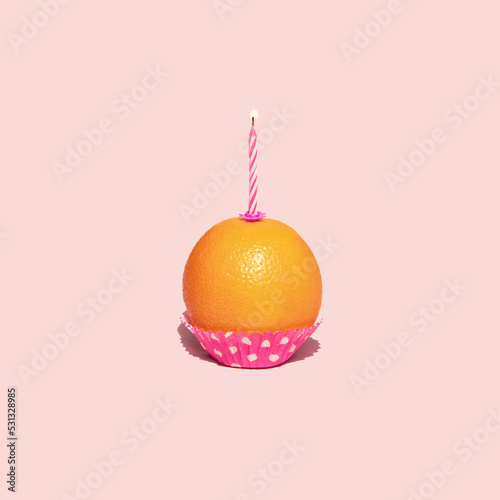 Healthy cupcake on pastel light pink background. Minimalistic food concept. Creative birthday composition.