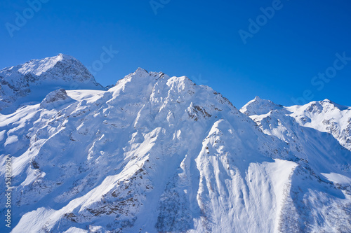Aerial view of snowy mountains on a sunny day