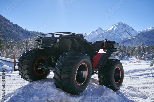 ATV with big wheels on the snow