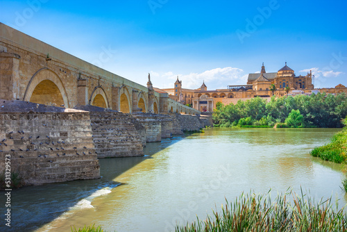 Cordoba, Spain. Roman Bridge on Guadalquivir river and The Great Mosque (Mezquita Cathedral) in the city of Cordoba, Andalusia. photo
