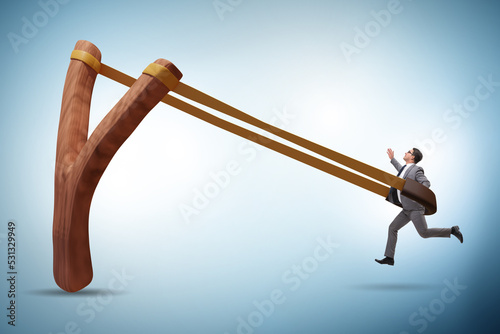 Businessman being launched from slingshot in career concept