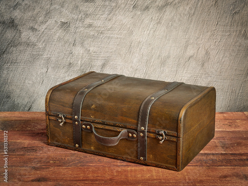 retro suitcase or storage box on wooden rustic table