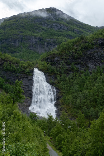 Wonderful landscapes in Norway. Hordaland. Beautiful scenery of  Fossen Bratte  Brattefossen  waterfall from the Eikedalselva river. Mountains  trees in background. Rainy day. Selective focus