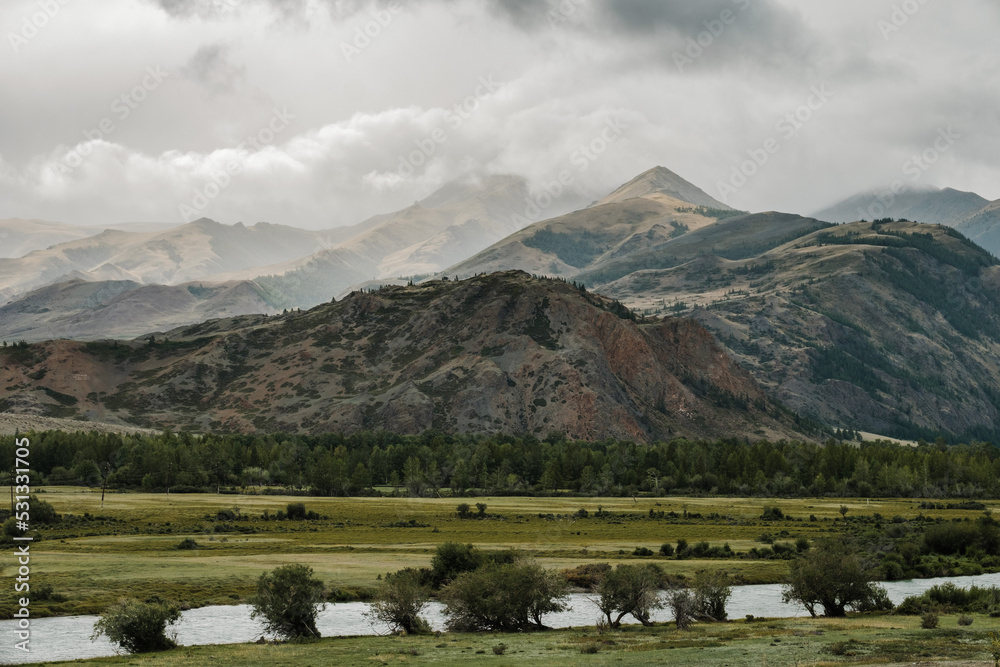 A beautiful Siberian landscape with a river against a background of mountains in the Altai Republic A beautiful Siberian landscape with a river against a background of mountains in the Altai Republic