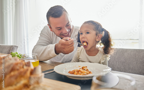 Father feed lunch food to girl for support with health  child development and growth while relax at home. Eating meal  dad or man feeding kid daughter while happy and enjoy quality time together
