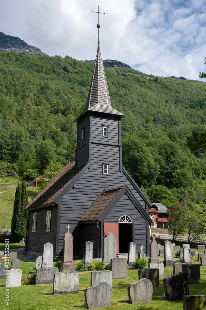 Flam, Norway - June 19, 2022: Flam church is a parish church of the Church of Norway in Aurland Municipality in Vestland county. 17h century. Cloudy spring day. Selective focus