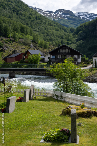 Flam, Norway - June 19, 2022: Flam church is a parish church of the Church of Norway in Aurland Municipality in Vestland county. 17h century. Cloudy spring day. Selective focus photo