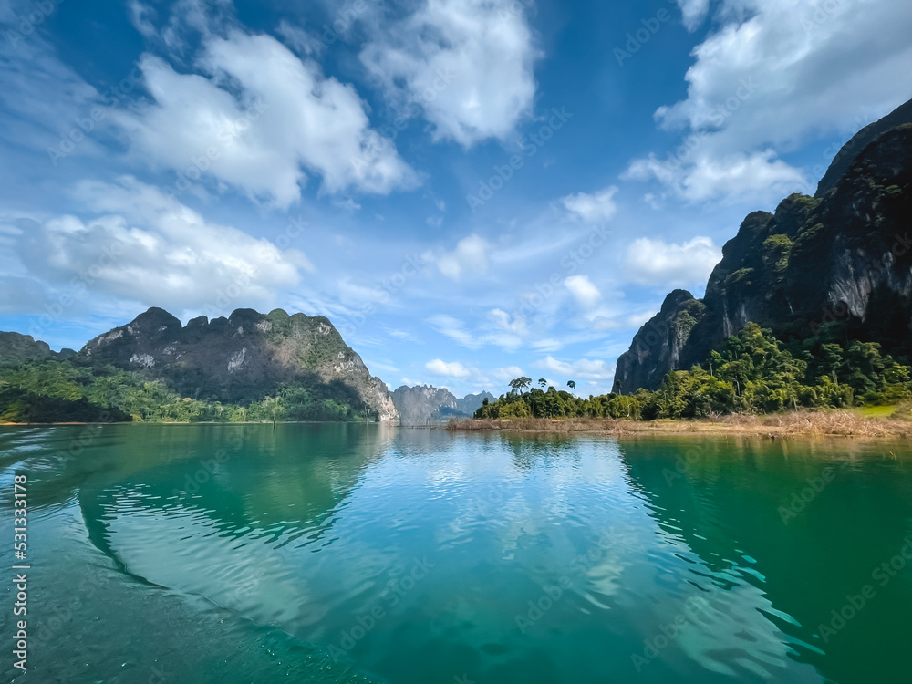 Emerland water lake in mountains. Amazing natural summer scenery. Stunning natural background. Popular touristic destination. Travel, tourism in Cheow Larn Lake - KHAO SOK National Park, Thailand
