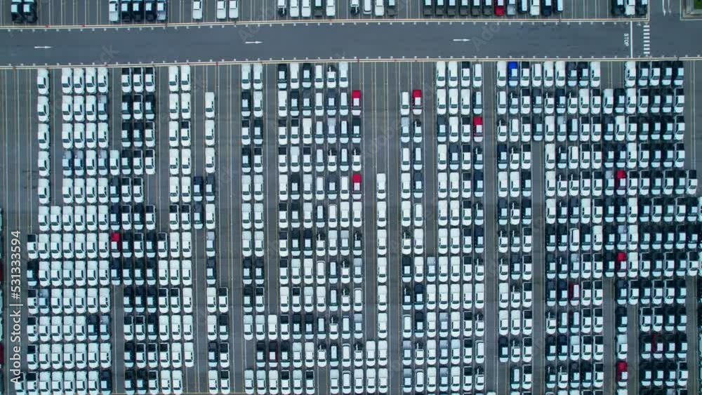 Drones flying above factory parking lot, new cars unsold. import and export industry. automotive industry. 4K
Drones flying above factory parking lot, new cars unsold. import and export industry. automotive industry. 4K