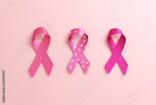 Three pink ribbons isolated on a pink background with copy space for Breast Cancer Awareness Month and World Cancer Day. Flyer, banner design template in 3D illustration