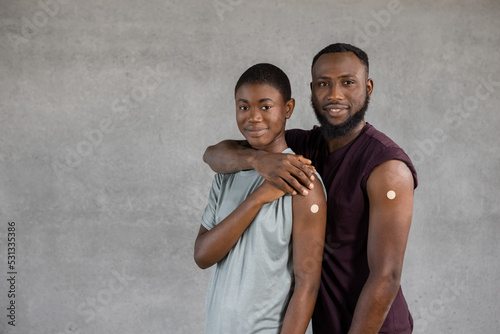 African American woman and man embracing each other with vaccination
