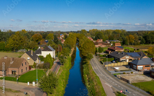 Aerial view of the Langelede canal crossing a residential area in Wachtebeke, Belgium