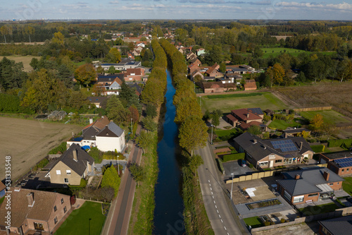 Aerial view of the Langelede canal crossing a residential area in Wachtebeke, Belgium photo