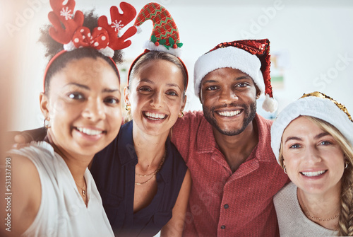 Friends, family and diversity in a Christmas selfie to celebrate the festive season. Black man, women and a happy smile at office xmas party. Team celebration and taking a holiday photo.