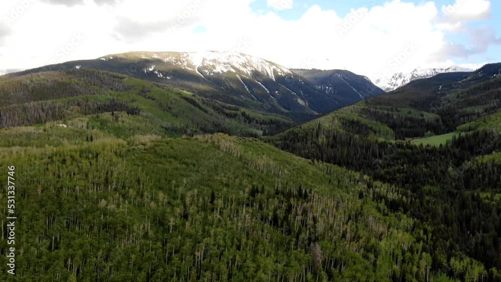 Aerial timelapse of snow capped peaks in summer in Vail, Colorado Aerial timelapse of snow capped peaks in summer in Vail, Colorado