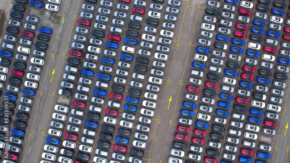 Drones is flying over a lot of cars parked in a automotive factory. new cars lined up for import and export. automobile industry. 4K
Drones is flying over a lot of cars parked in a automotive factory. new cars lined up for import and export. automobile industry. 4K